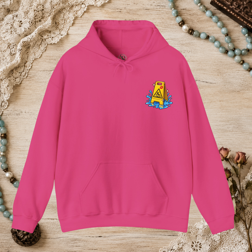 Front of a heliconia pink unisex hoodie with a small yellow wet-floor caution graphic on the left chest