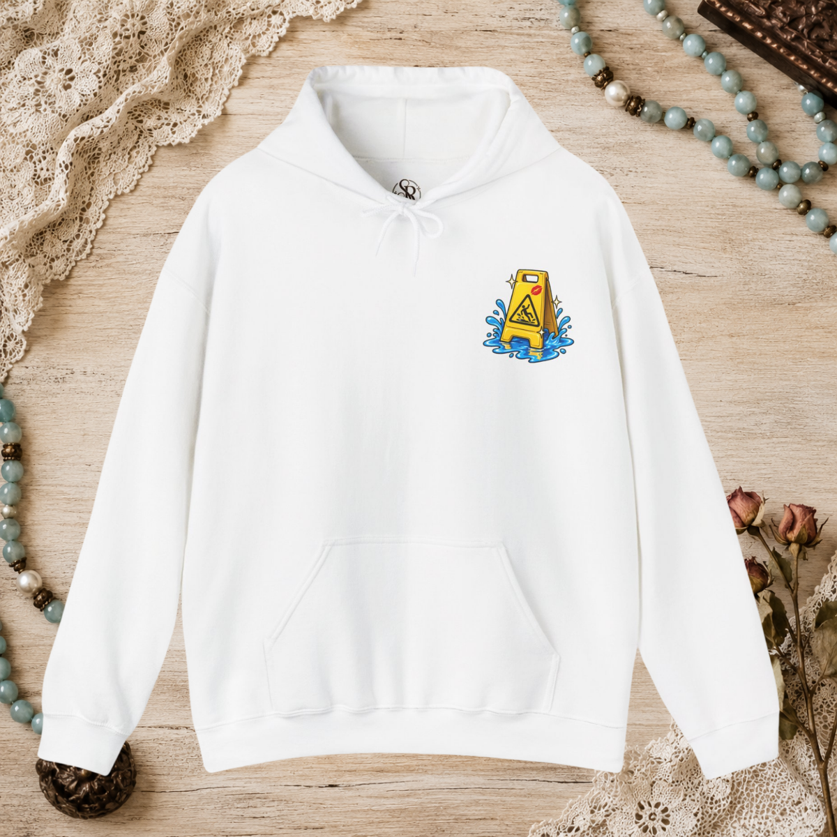 Front of a white unisex hoodie with a small yellow wet-floor caution graphic on the left chest