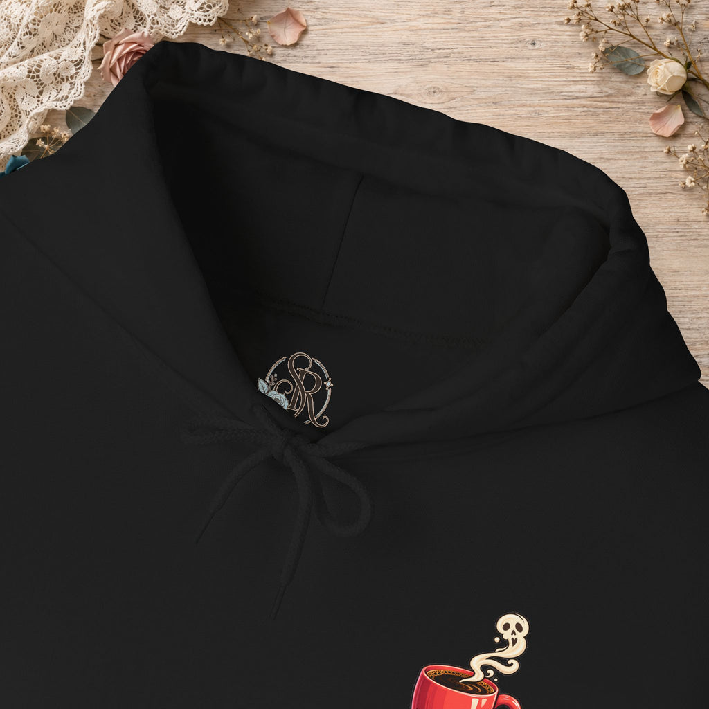 Close-up of the black hoodie neckline and small red coffee cup front design