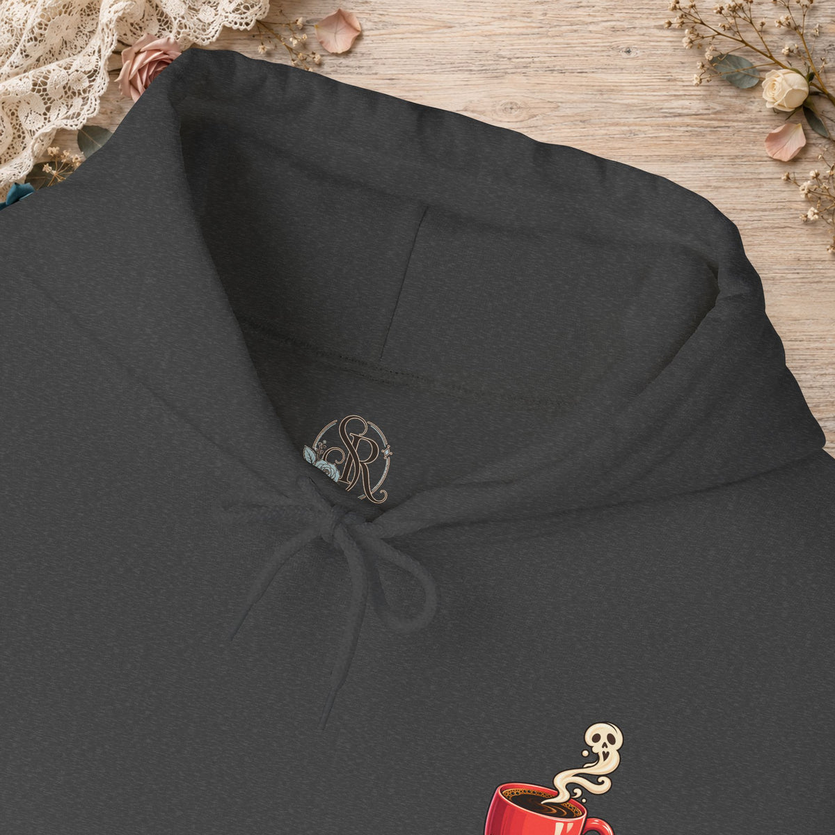 Close-up of the Dark Heather hoodie neckline and small red coffee cup front design
