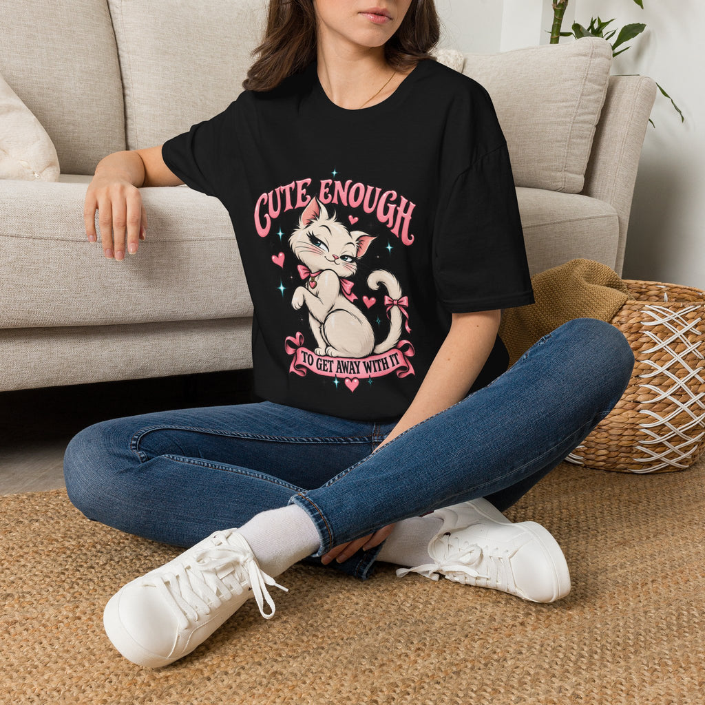 Woman seated on a sofa wearing a Black Cute Enough to Get Away With It unisex graphic T-shirt