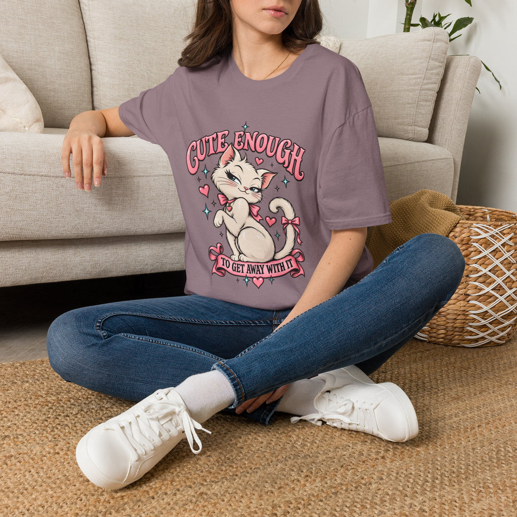 Woman seated on a sofa wearing a Heather Berry Cute Enough to Get Away With It unisex graphic T-shirt