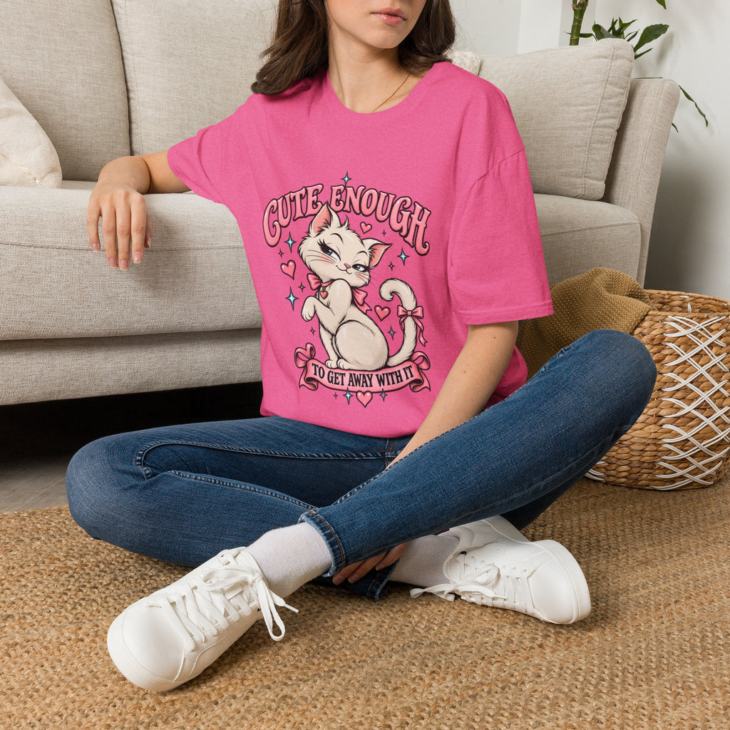 Woman seated on a sofa wearing a Heather Heliconia Cute Enough to Get Away With It unisex graphic T-shirt