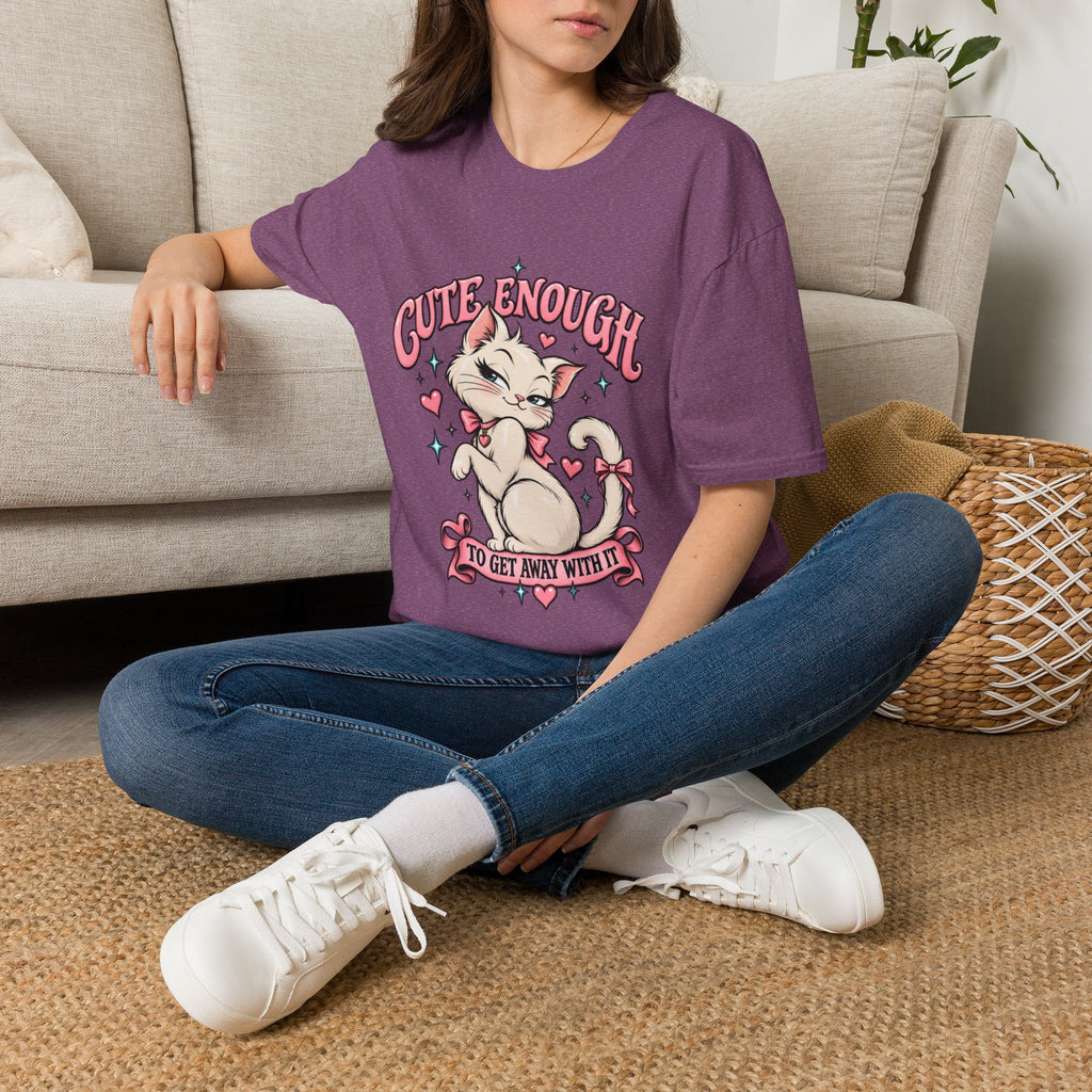 Woman seated on a sofa wearing a Heather Maroon Cute Enough to Get Away With It unisex graphic T-shirt