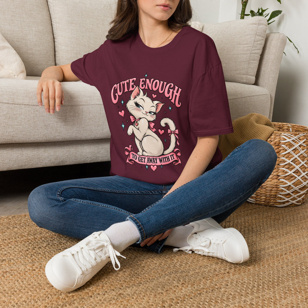 Woman seated on a sofa wearing a Maroon Cute Enough to Get Away With It unisex graphic T-shirt