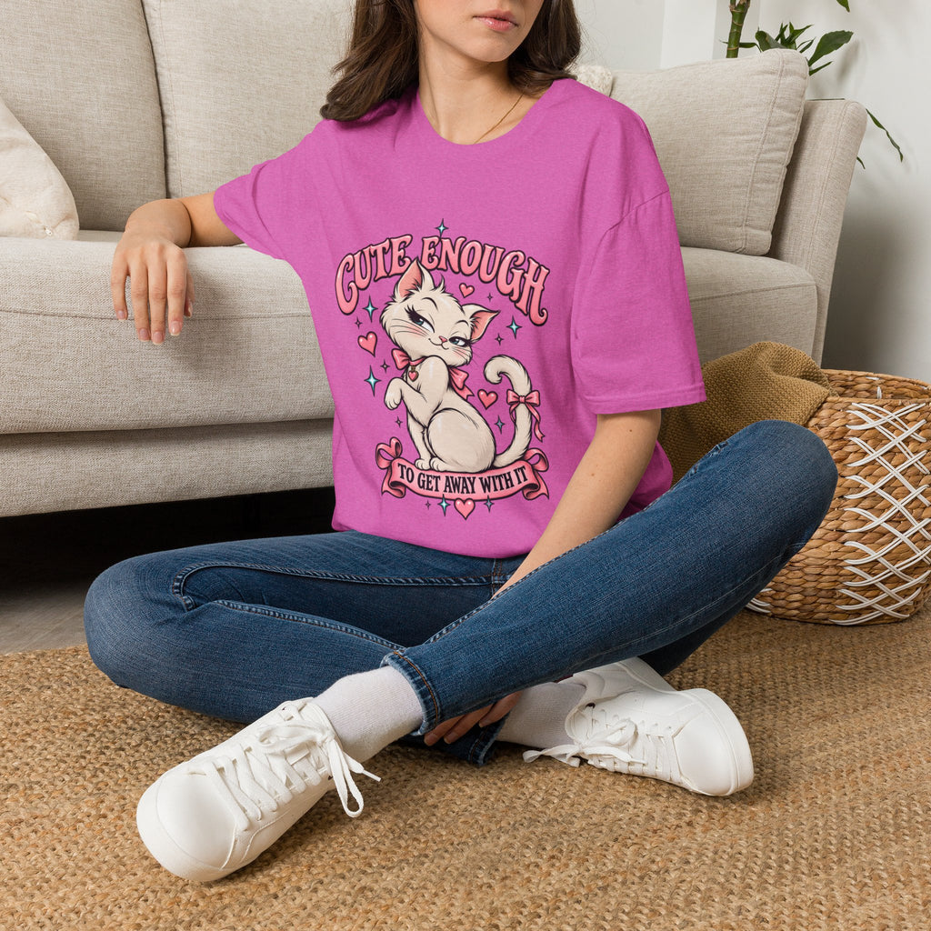 Woman seated on a sofa wearing a Paragon Cute Enough to Get Away With It unisex graphic T-shirt