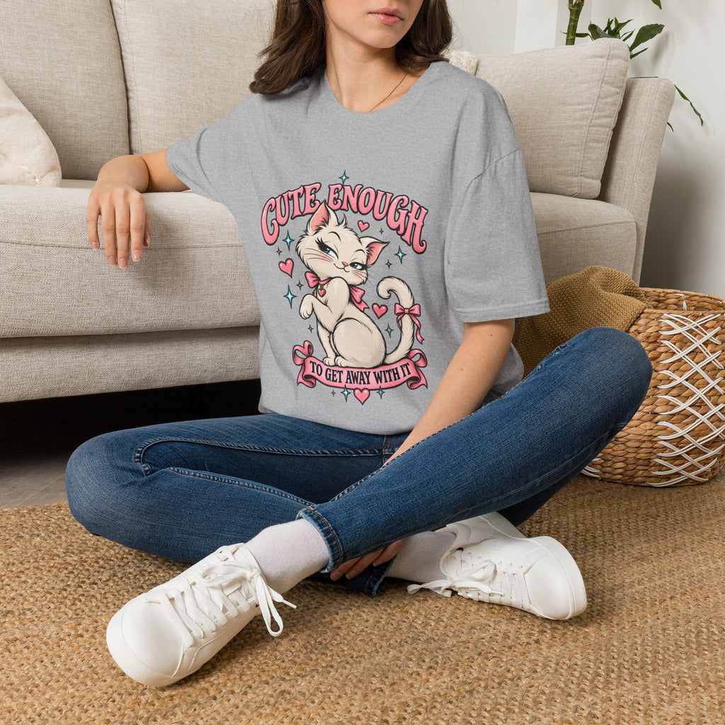 Woman seated on a sofa wearing a Sport Grey Cute Enough to Get Away With It unisex graphic T-shirt