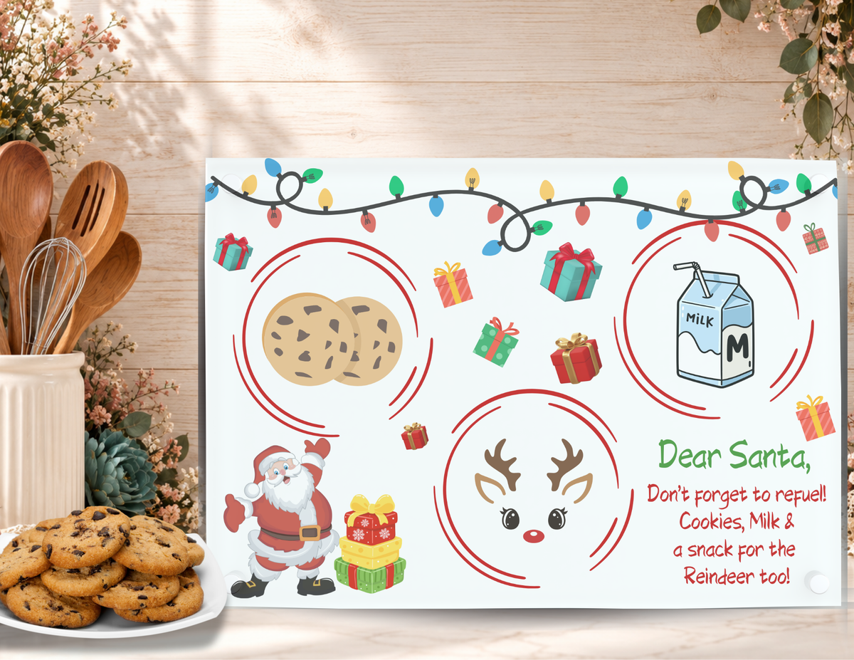 Santa Refuel Christmas cookie tray displayed beside a plate of chocolate chip cookies in a festive kitchen