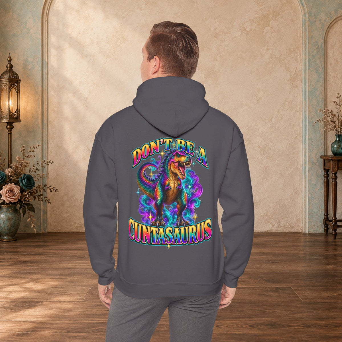 Man wearing a charcoal Don’t Be a Cuntasaurus adult-humor graphic hoodie