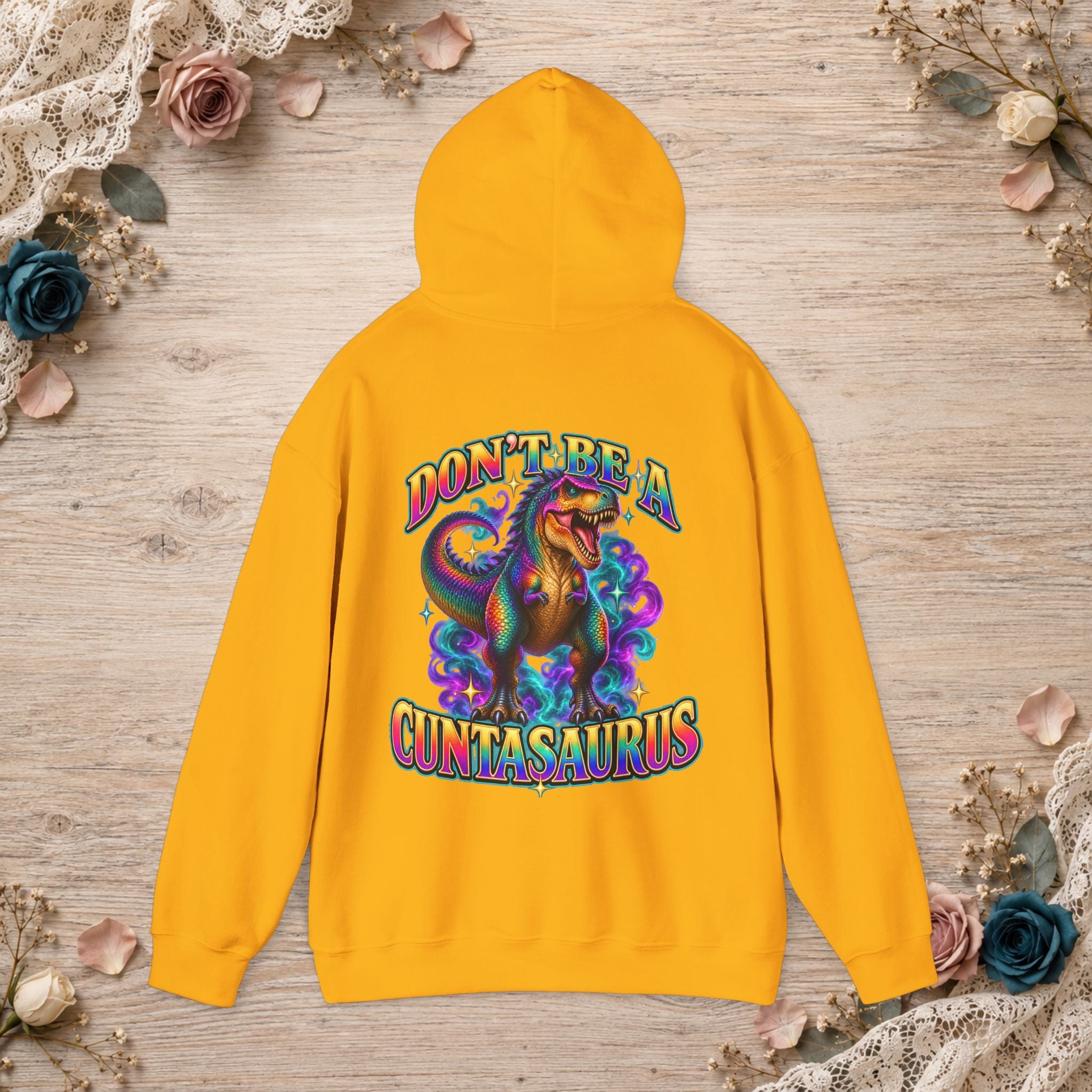 Gold Don’t Be a Cuntasaurus graphic hoodie with a vibrant rainbow dinosaur design