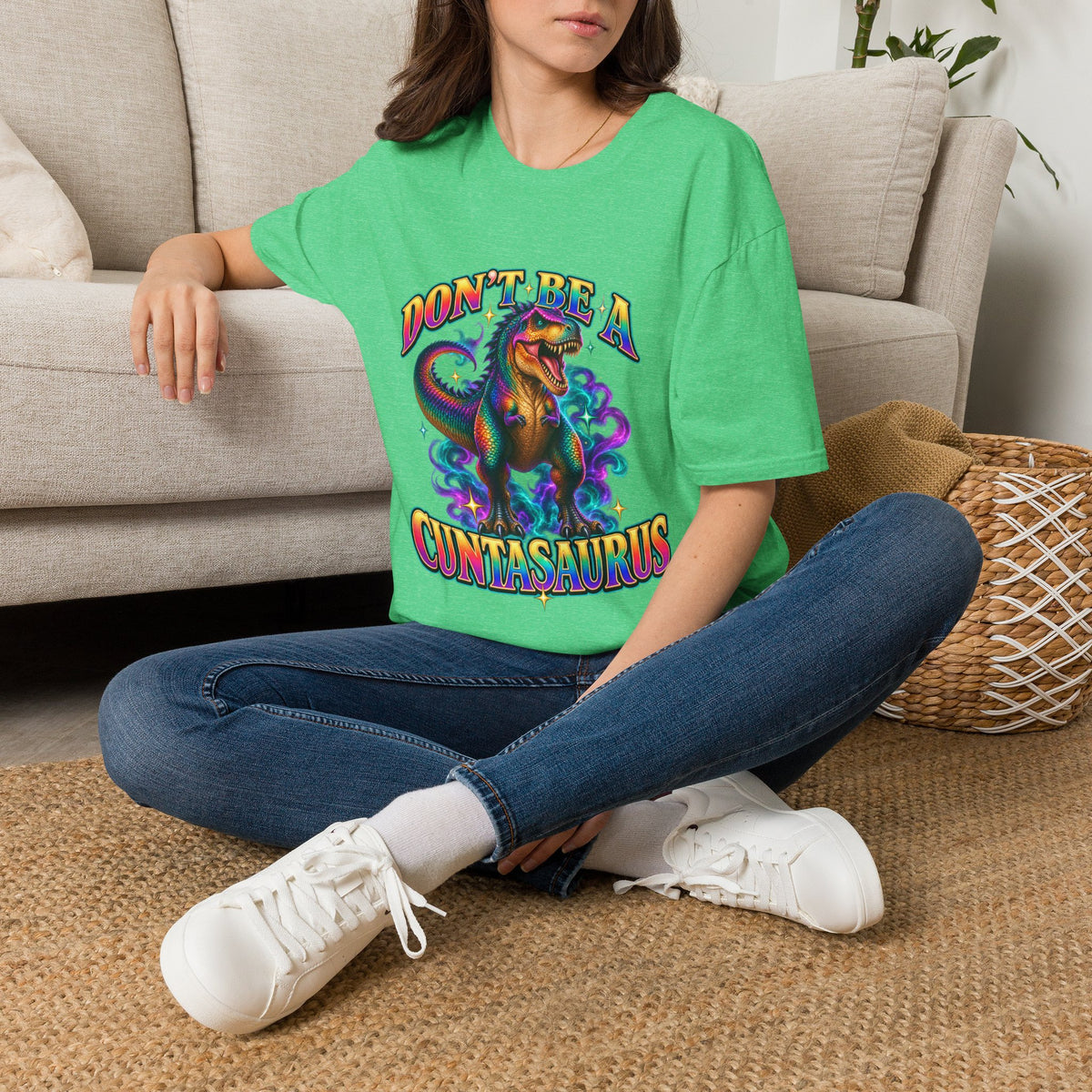 Woman wearing a heather Irish green Don’t Be a Cuntasaurus colorful dinosaur graphic tee