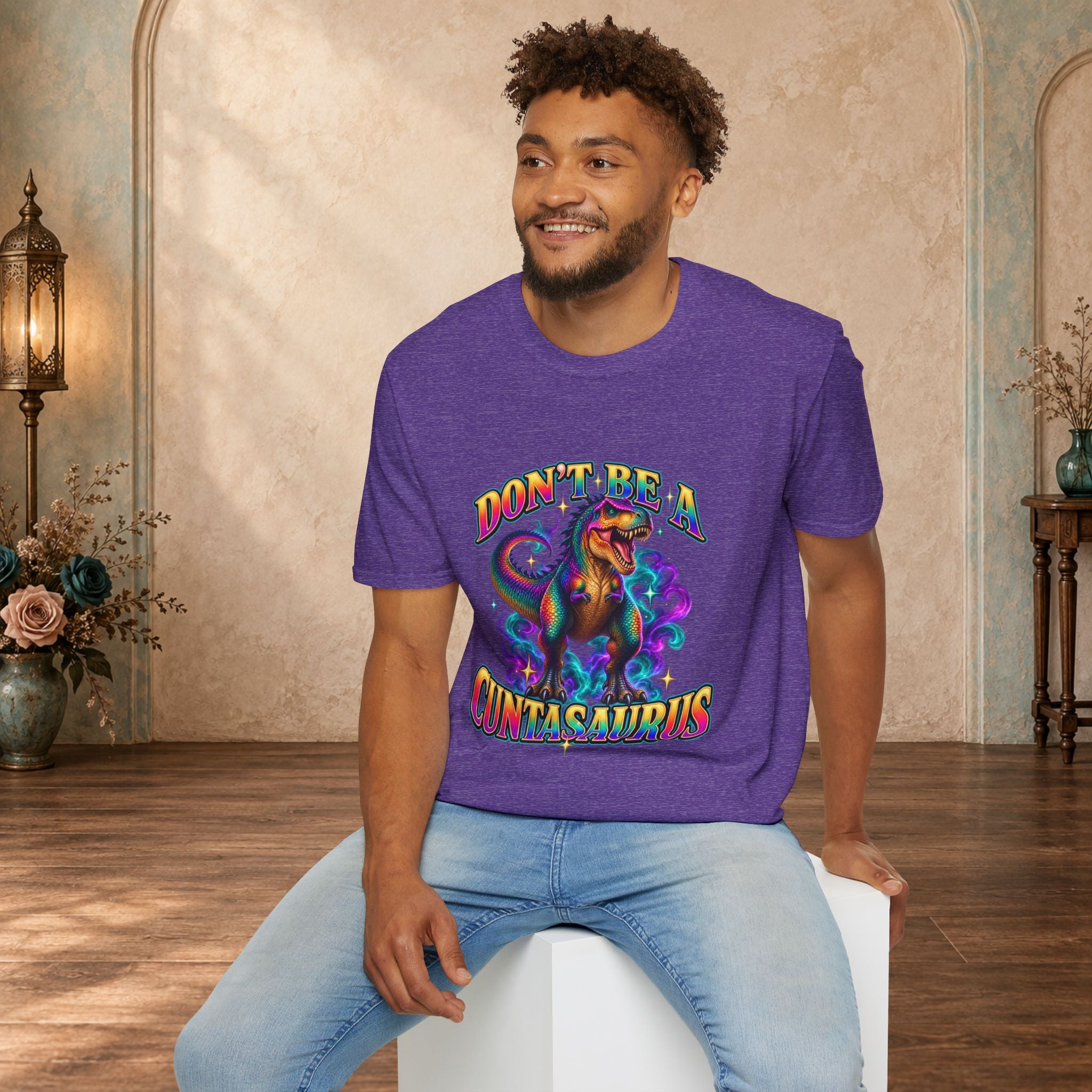 Man wearing a heather purple Don’t Be a Cuntasaurus colorful graphic T-shirt