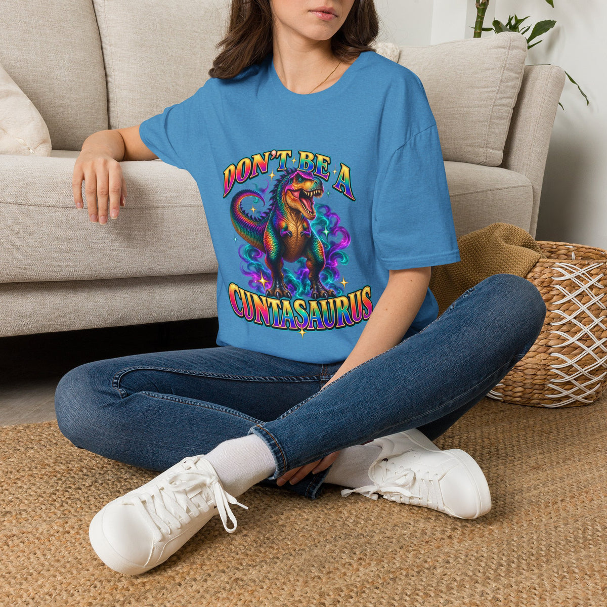 Woman wearing a heather sapphire Don’t Be a Cuntasaurus funny graphic T-shirt