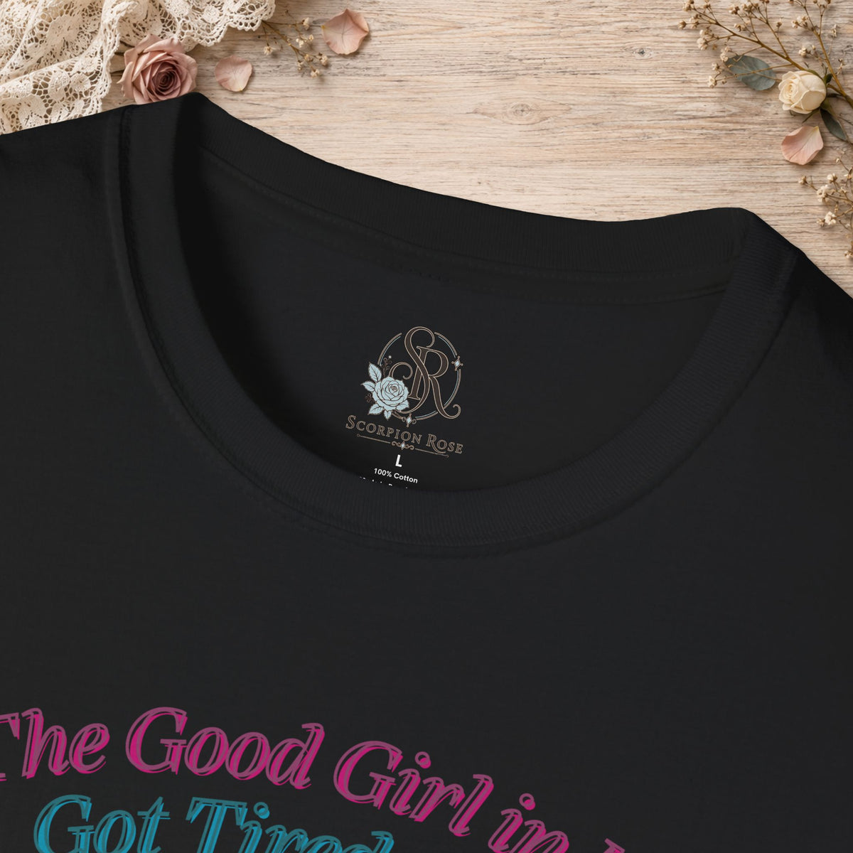 Close-up of the Black Good Girl in Me T-shirt neckline and printed artwork