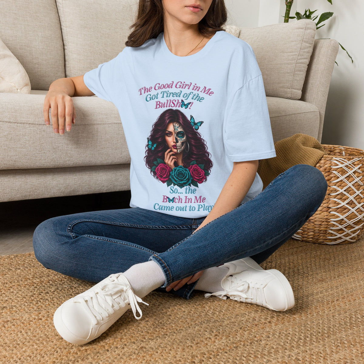 Seated woman wearing a Light Blue Good Girl in Me graphic T-shirt