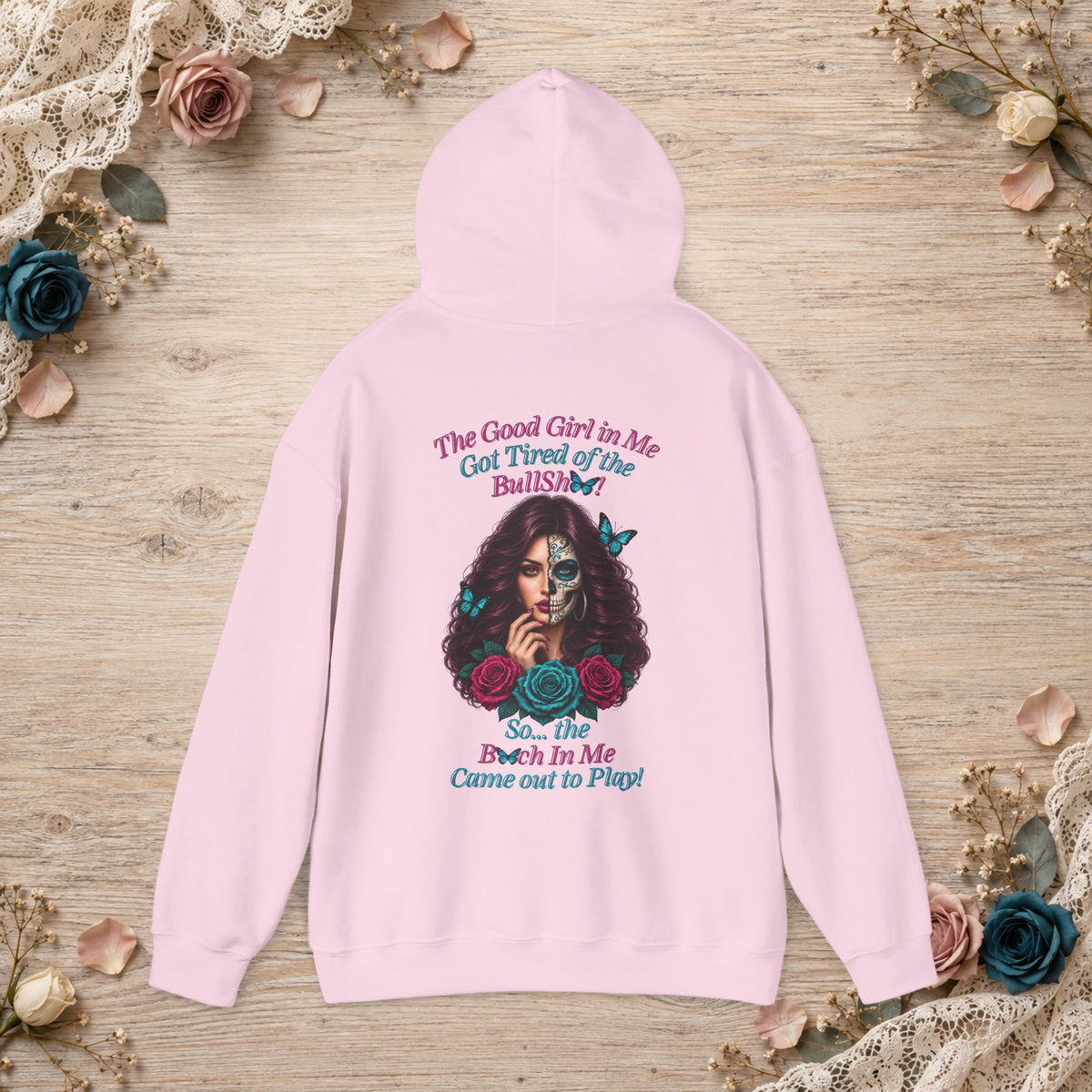 Back of light pink hoodie featuring the Good Girl sugar skull woman, roses, butterflies and statement quote