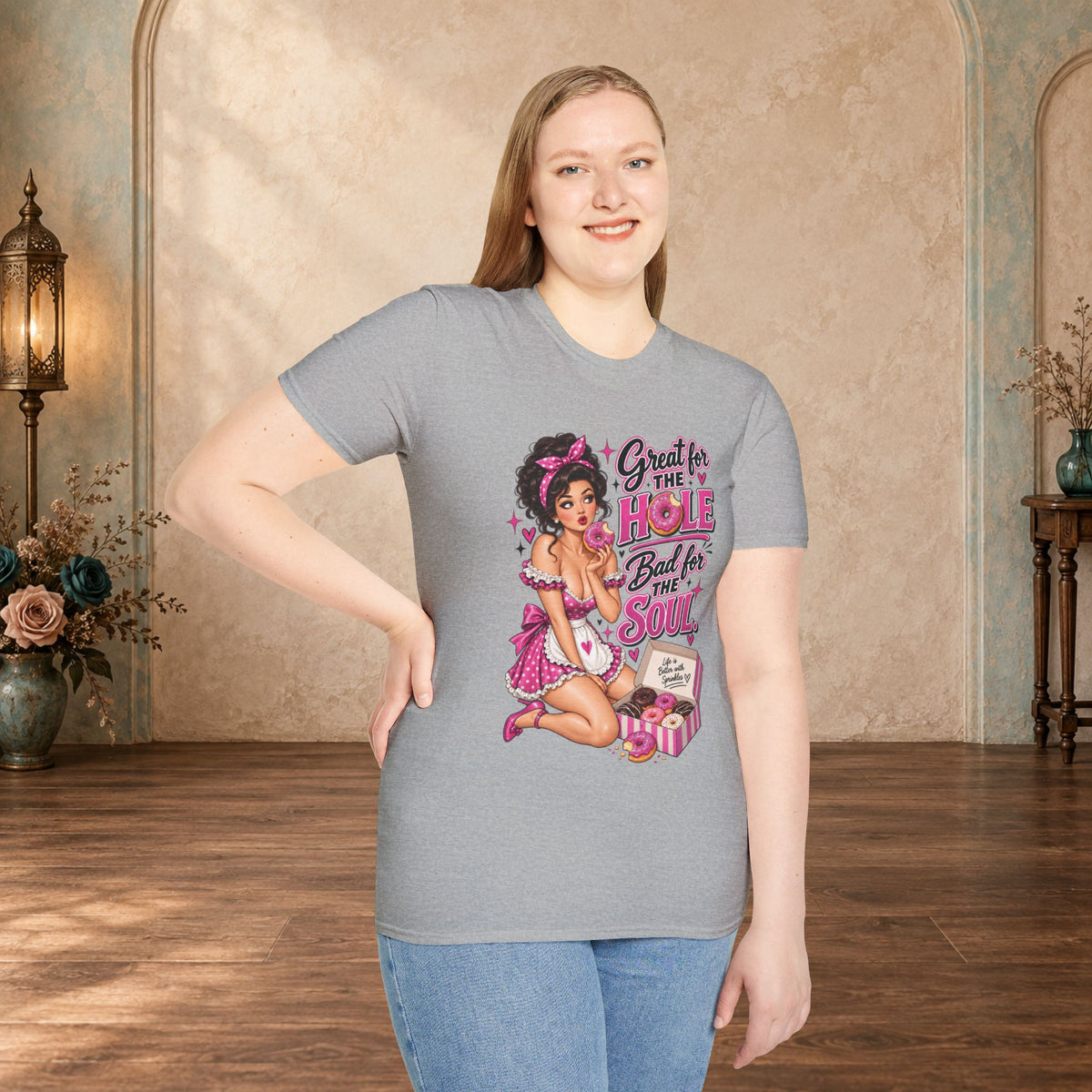 Woman modeling a Sport Grey unisex T-shirt featuring the Great for the Hole, Bad for the Soul pink pin-up design.