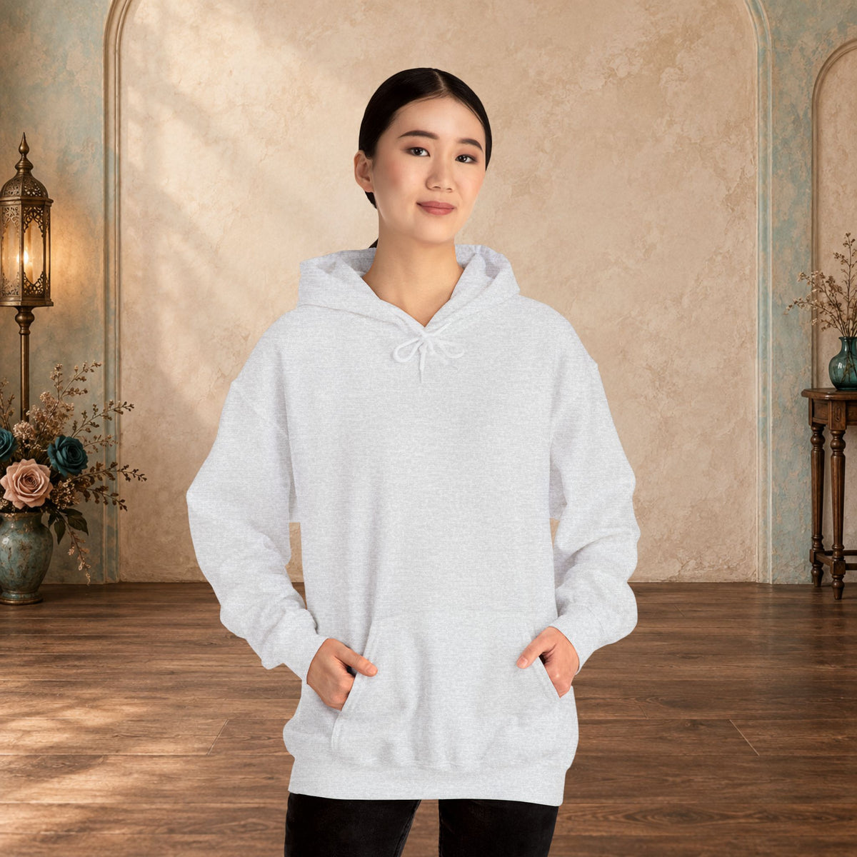 Female model wearing the blank front of an Ash I Give Awesome Headaches unisex hoodie