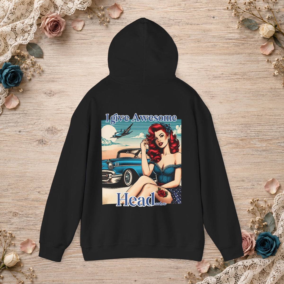 Black unisex hoodie shown flat with I Give Awesome Headaches retro pin-up artwork on the back