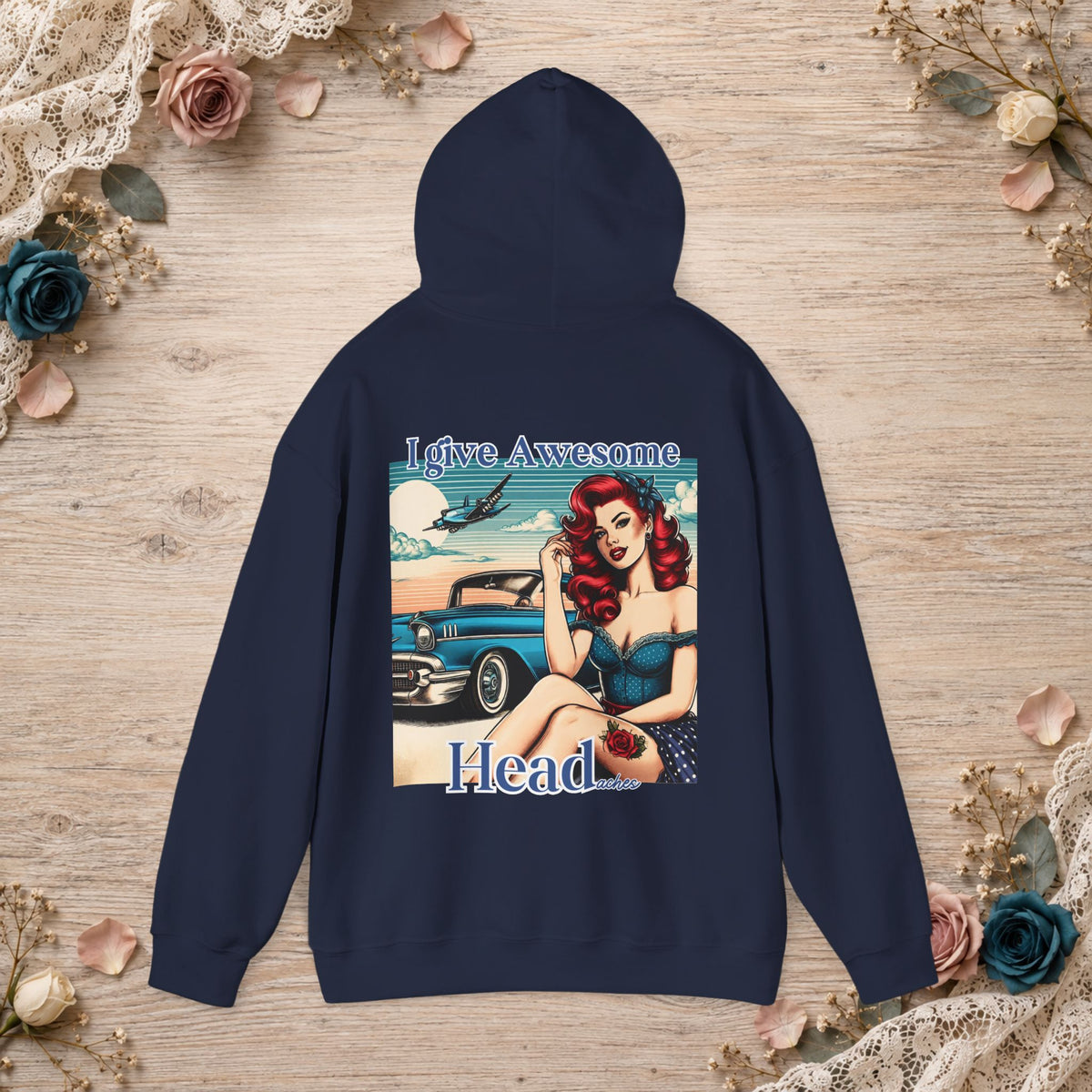 Navy unisex hoodie shown flat with I Give Awesome Headaches retro pin-up design printed on the back