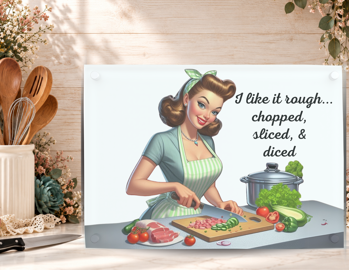 I Like It Rough tempered glass cutting board displayed with a kitchen knife, utensils, and floral accents