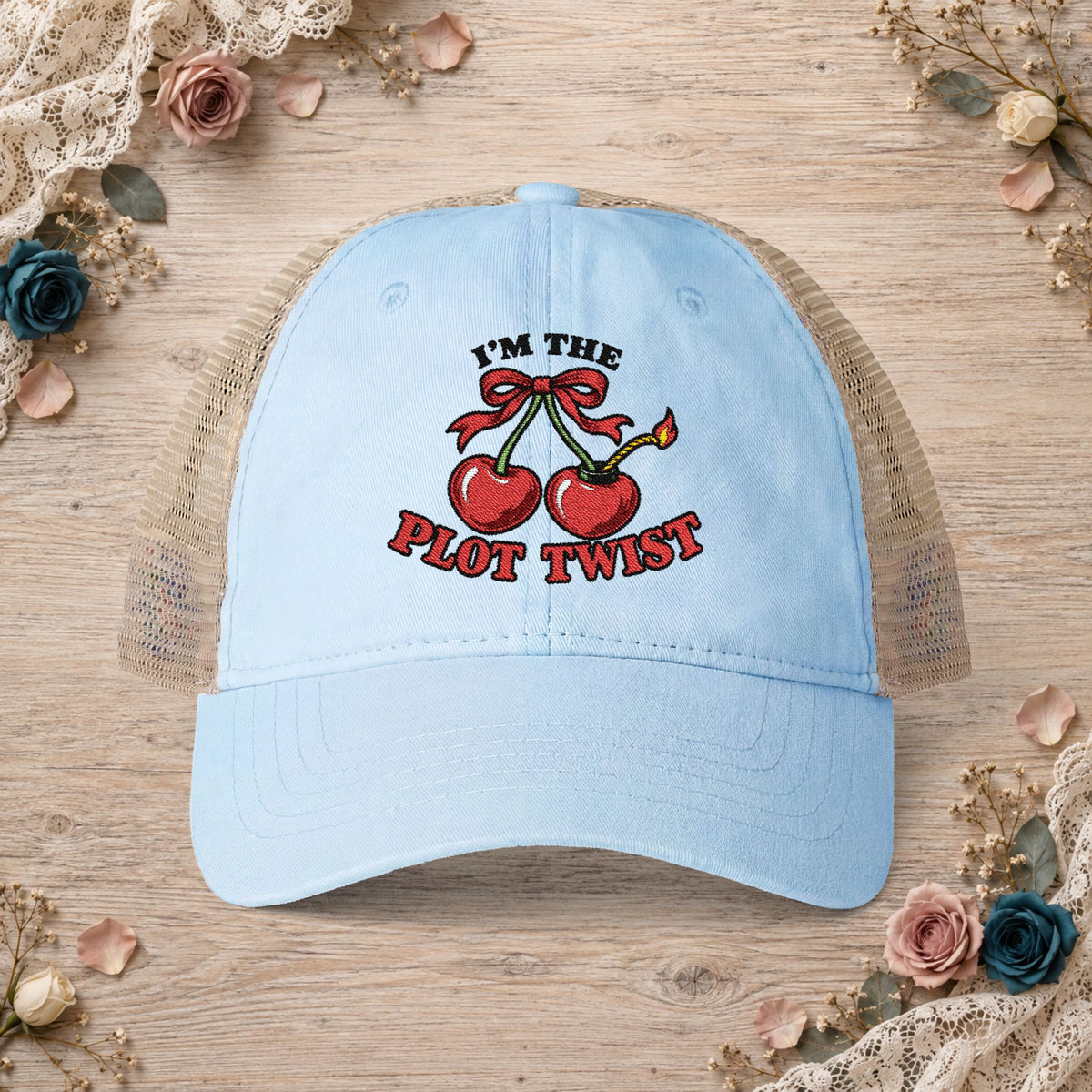 Cashmere blue women’s mesh-back hat with an embroidered I’m the Plot Twist cherry bomb design.