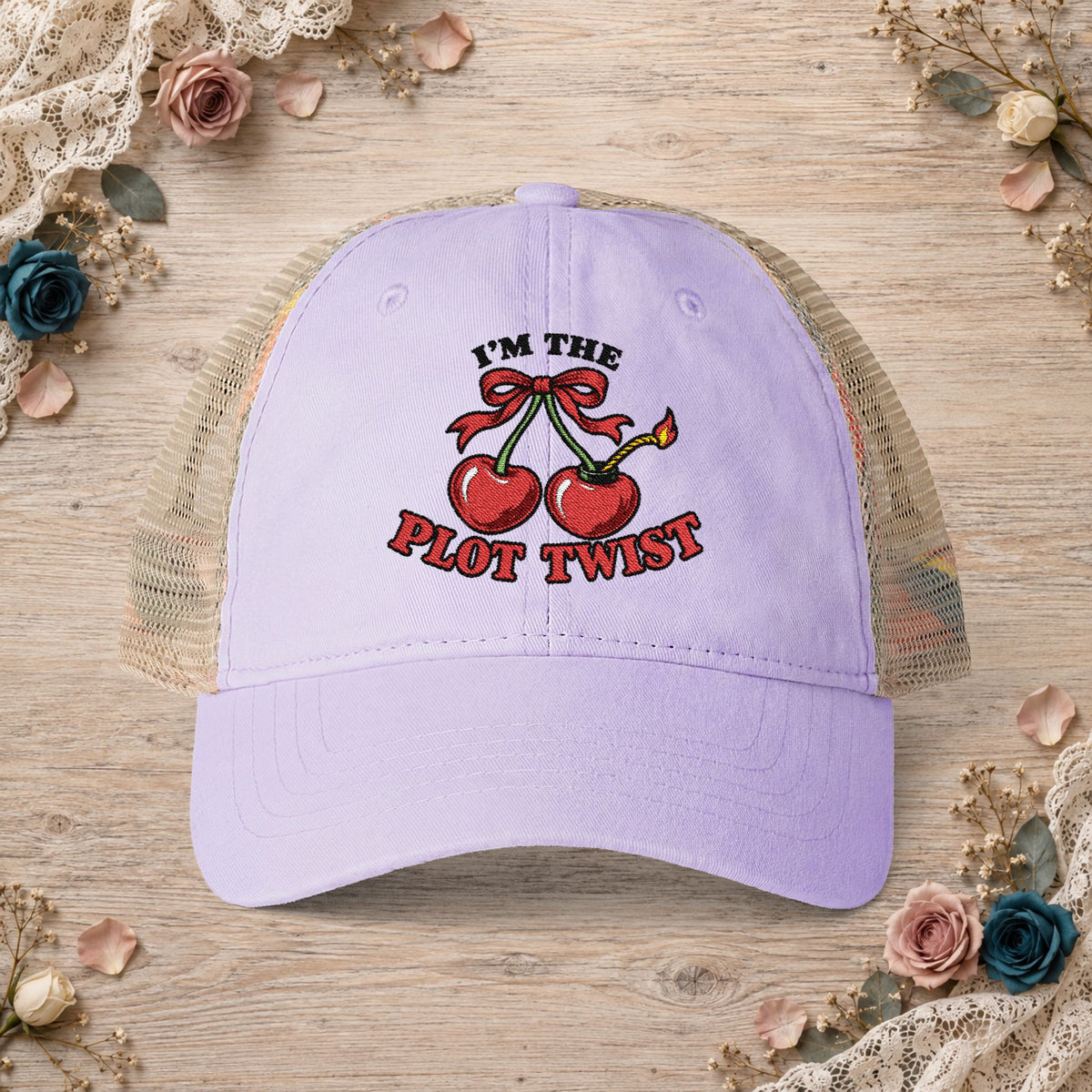 Lavender women’s mesh-back hat with an embroidered I’m the Plot Twist cherry bomb design.