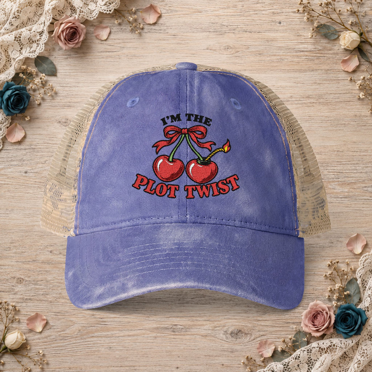 Violet women’s mesh-back hat with an embroidered I’m the Plot Twist cherry bomb design.