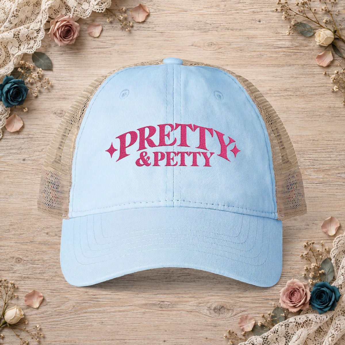 Cashmere blue Pretty and Petty embroidered ponytail trucker hat front view