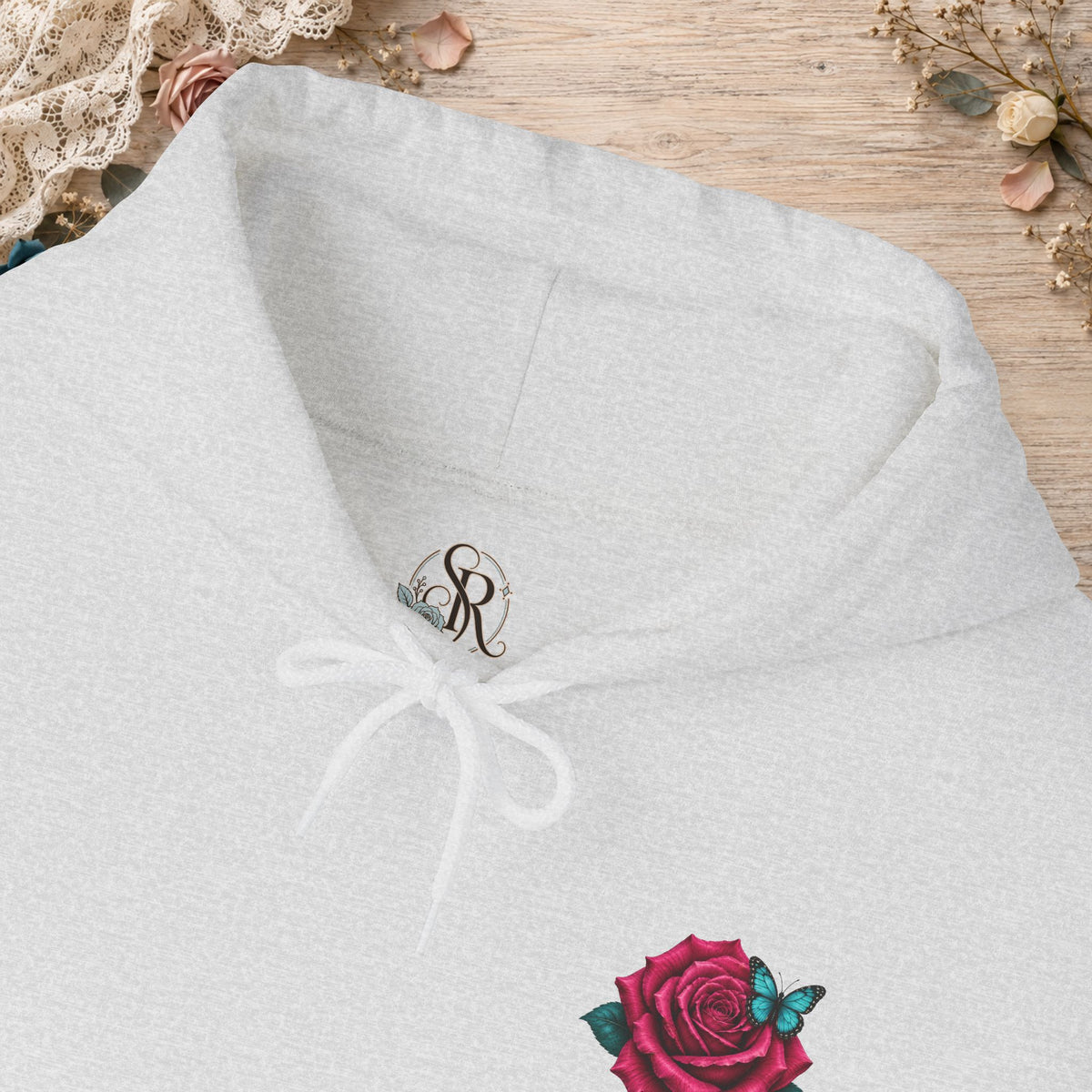 Close-up of the custom Scorpion Rose Designs inner neck label and rose-and-butterfly chest print