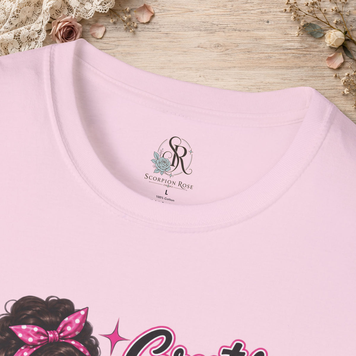 Close-up of the light pink T-shirt neckline showing the printed Scorpion Rose Designs inner neck label.