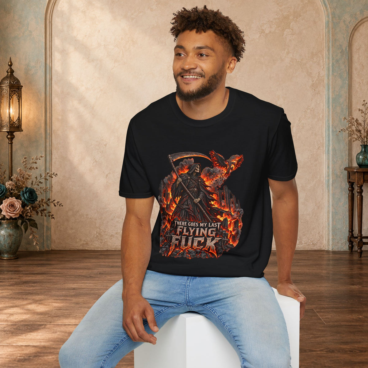 Seated man wearing a Black There Goes My Last Flying Fuck Grim Reaper graphic T-shirt