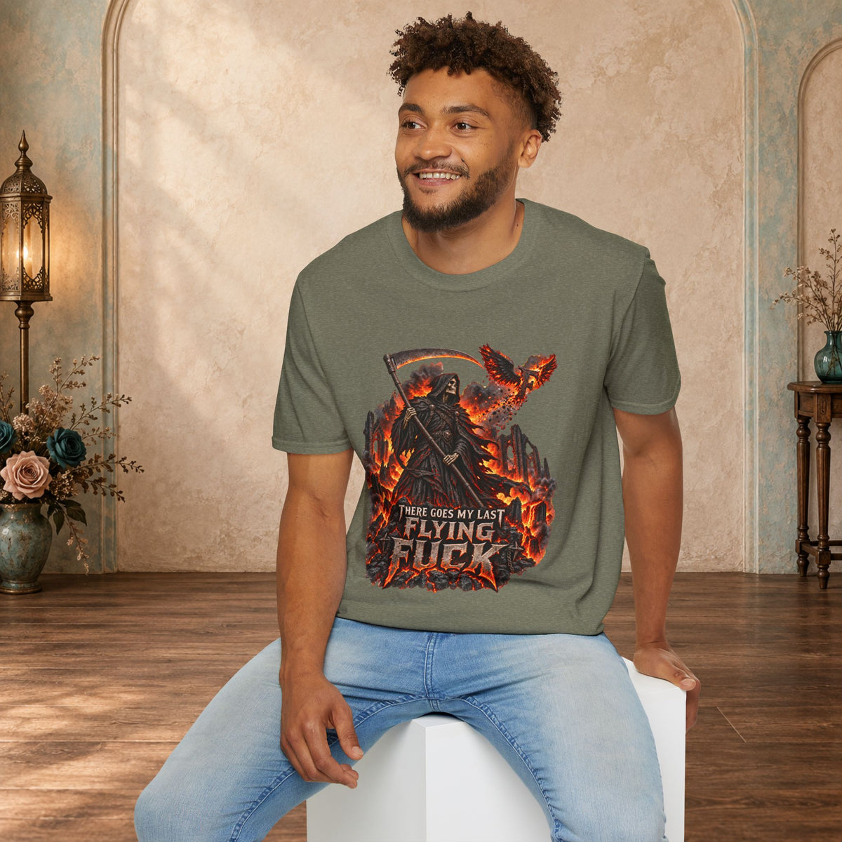 Seated man modeling a Heather Military Green There Goes My Last Flying Fuck Grim Reaper T-shirt
