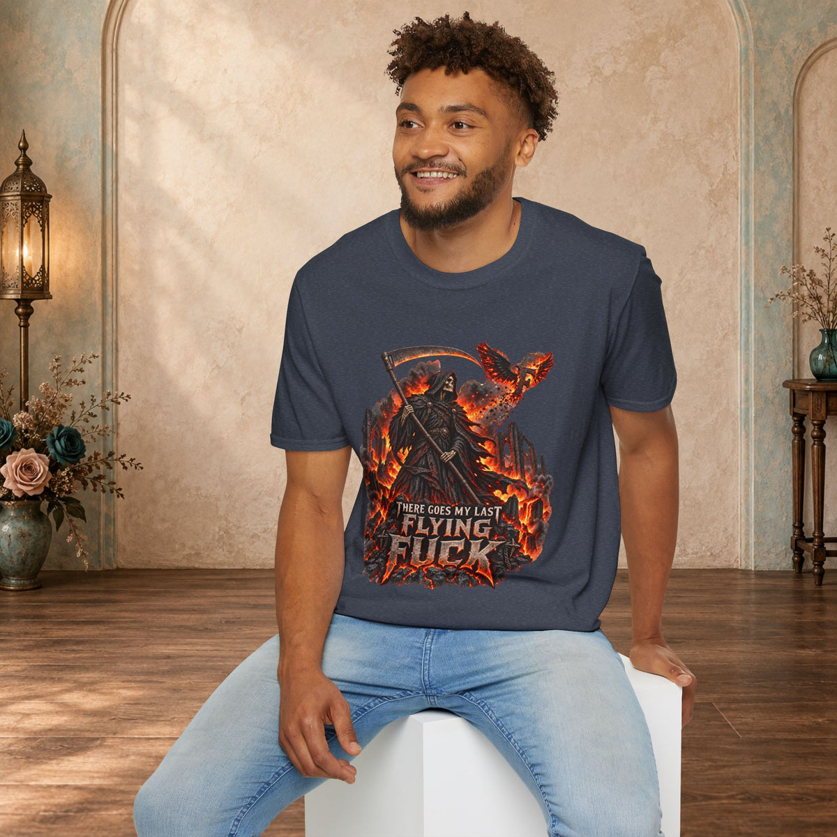 Seated man wearing a Heather Navy There Goes My Last Flying Fuck Grim Reaper graphic T-shirt